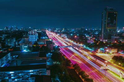 Light trails on road in city at night