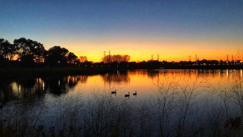 Scenic view of lake against sky during sunset