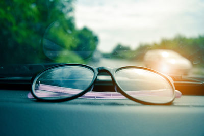 Close-up of eyeglasses on car dashboard