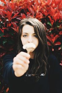 Portrait of beautiful young woman with arms raised