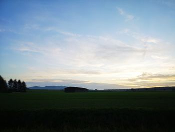 Scenic view of field against sky during sunset