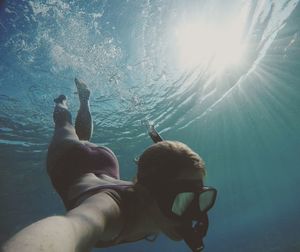 Woman swimming in sea with snorkel mask 