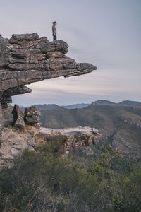 Woman stands at the top of the balconies and looks the landscape of the grampians national park, victoria, australia