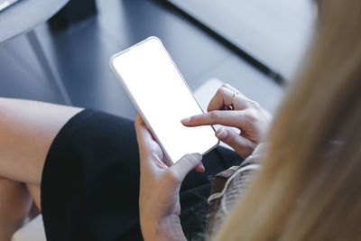 Midsection of man using mobile phone