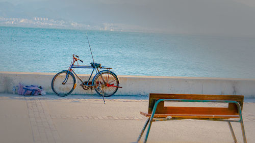 Bicycle on beach against sea