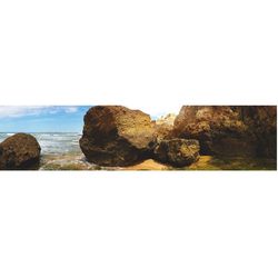 Rocks on sea against sky