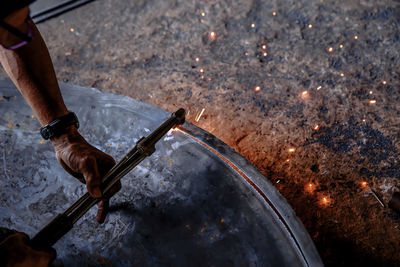 Close-up of man working on metal