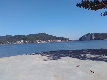 View of calm sea against clear blue sky