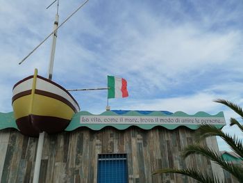 Low angle view of flags hanging against building