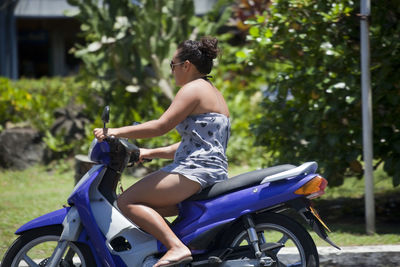 Side view of woman riding bicycle