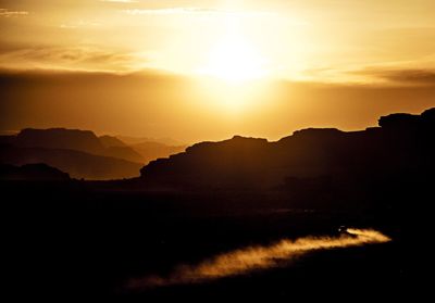 Scenic view of silhouette mountains against sky during sunset