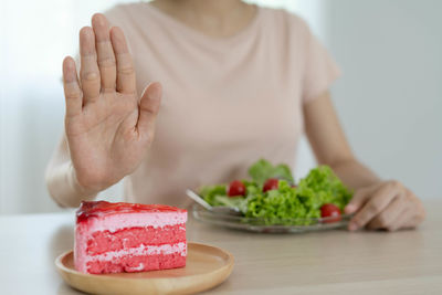 Midsection of man holding ice cream in plate