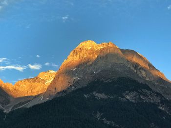 Low angle view of rocky mountains against sky