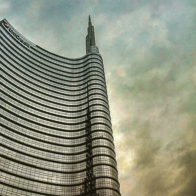 low angle view, building exterior, architecture, built structure, sky, tall - high, tower, cloud - sky, modern, city, skyscraper, cloudy, cloud, building, outdoors, office building, no people, tall, day, famous place