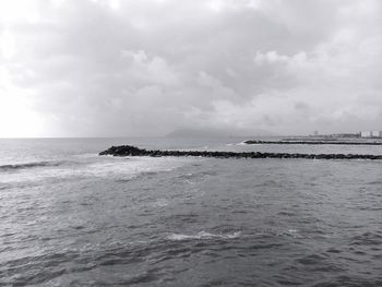 Scenic view of sea against cloudy sky