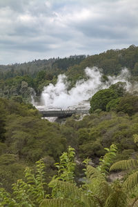 Scenic view of waterfall against sky