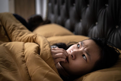 Portrait of boy lying on sofa