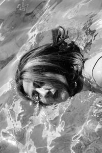 High angle portrait of woman swimming in pool