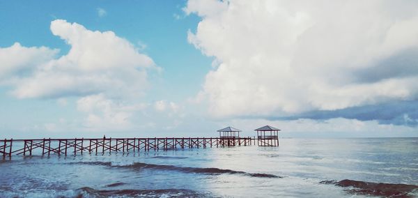 Pier over sea against sky