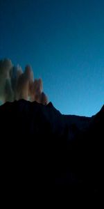 Scenic view of silhouette mountains against sky at night