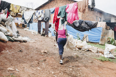 Low section of woman walking on field in slum