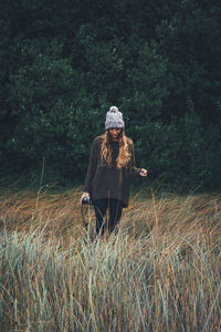 Woman standing on plants