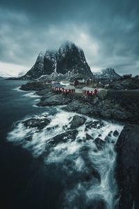 Scenic view of sea and mountain against sky