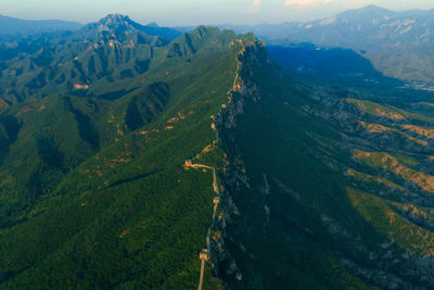 High angle view of valley and mountains against sky