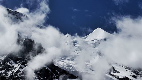 Scenic view of mountains against cloudy sky