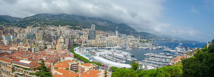 High angle view of city by sea against sky