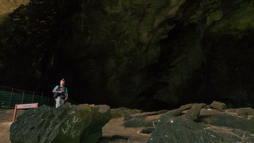 People standing on rock by mountain