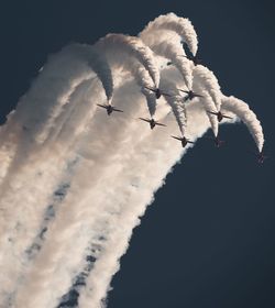 Low angle view of airplane flying against sky