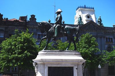 Low angle view of statue against building