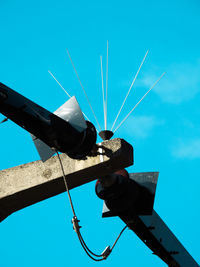 Low angle view of airplane against clear blue sky