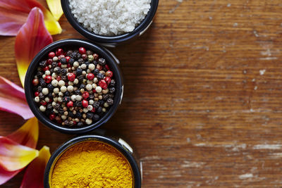 Close-up of various food in bowl by petal on table