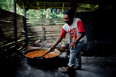 Full length of man preparing food