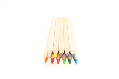 Close-up of multi colored pencils against white background