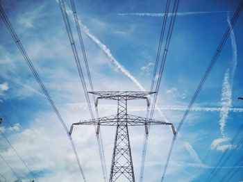 Low angle view of electricity pylon against sky