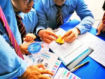 High angle view of people sitting on table