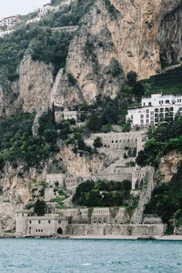 Low angle view of hotel on rocky coastline