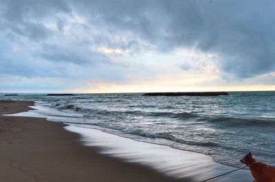 Scenic view of beach against sky during sunset