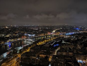 High angle view of illuminated cityscape against sky at night