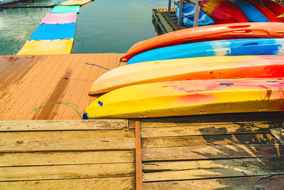 Close-up of multi colored boats moored at pier