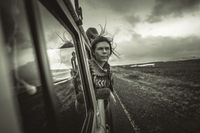 Portrait of woman on field against sky