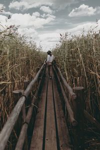 Woman walking on footbridge