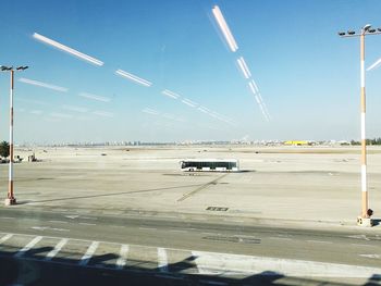 Airplane on airport runway against sky