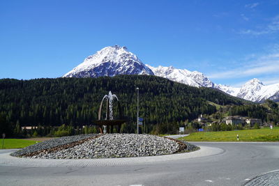 Scenic view of snowcapped mountains against blue sky