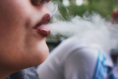 Close-up of woman exhaling smoke