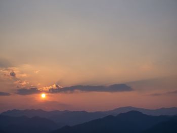 Scenic view of silhouette mountains against sky during sunset