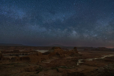 Scenic view of landscape against sky at night